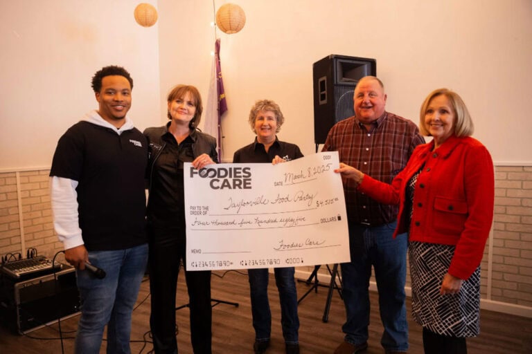 Team holding Cheque for Foodies Care - a nonprofit initiative by Client Focused Media