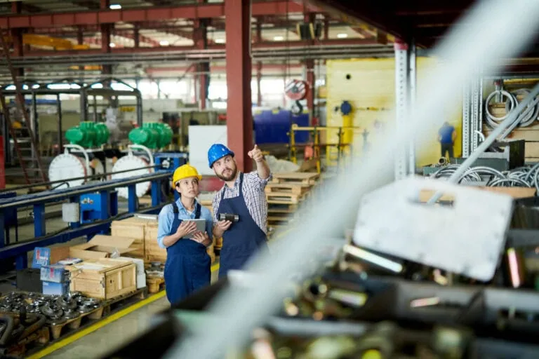 two workers checking inventory/stock in warehouse