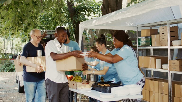 Volunteers feeding the needy with Meal Boxes